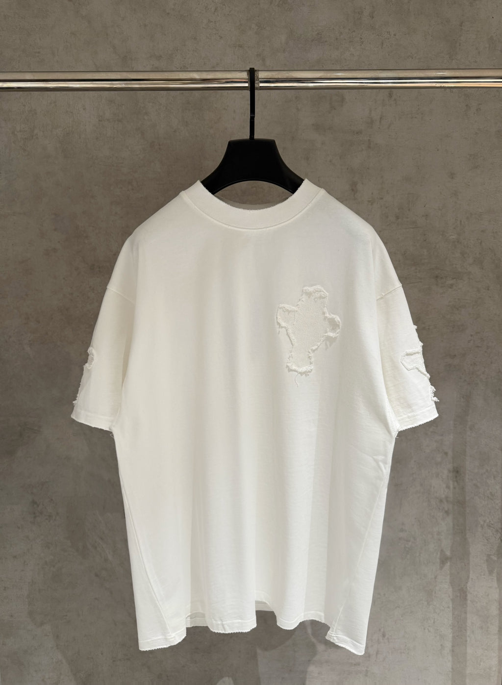 White short-sleeve T-shirt with large embroidered cross design on the chest