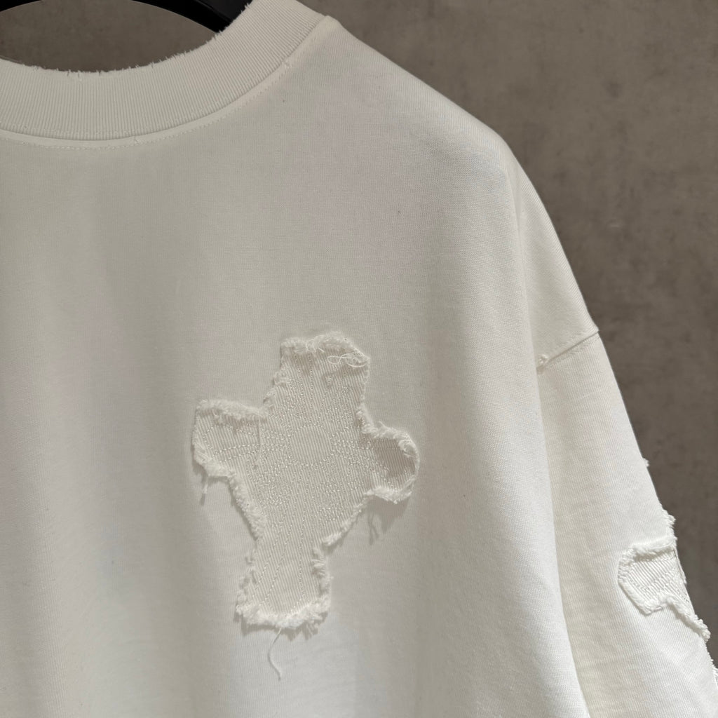White short-sleeve T-shirt with small embroidered cross on the sleeve side
