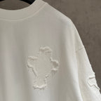 White short-sleeve T-shirt with small embroidered cross on the sleeve side