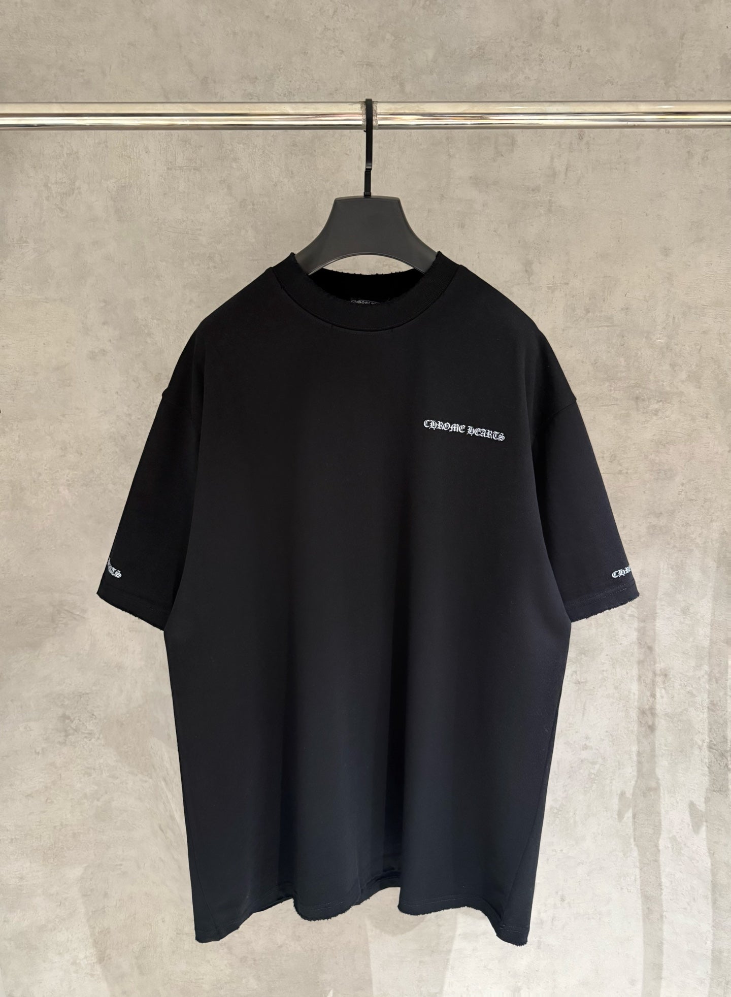Black short-sleeve T-shirt with small chest logo print and crew neckline