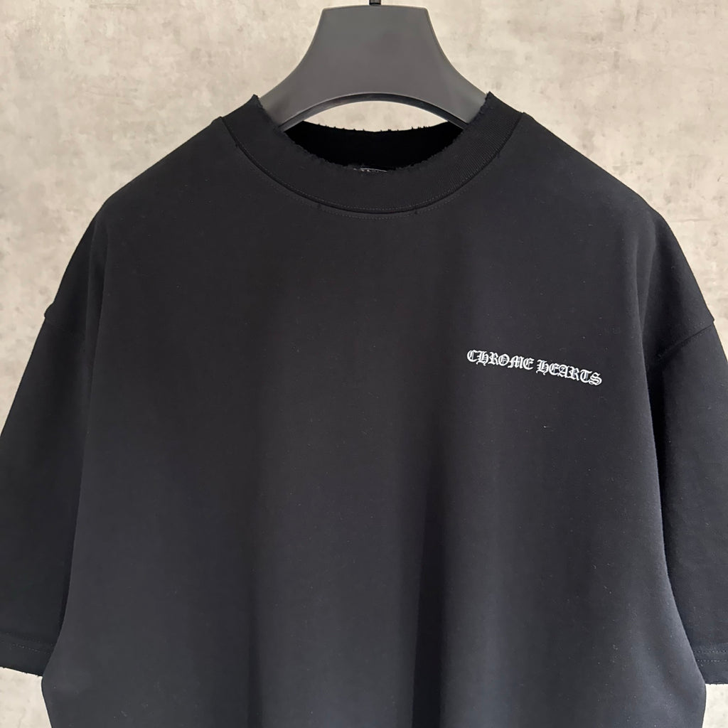 Black short-sleeve T-shirt, close view of crew neck and small chest logo