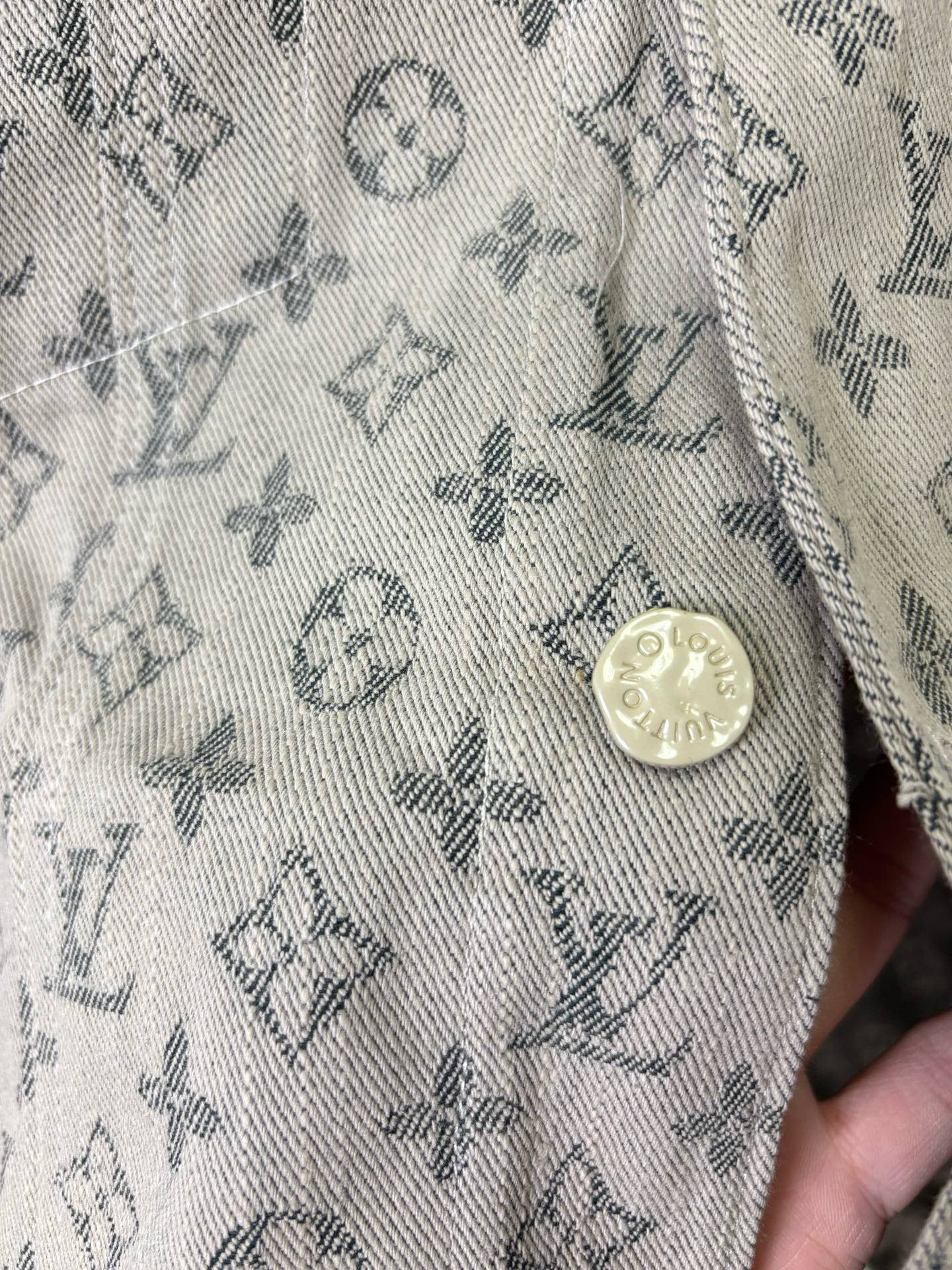 Louis Vuitton monogram long-sleeve jacket fabric close-up with small round button