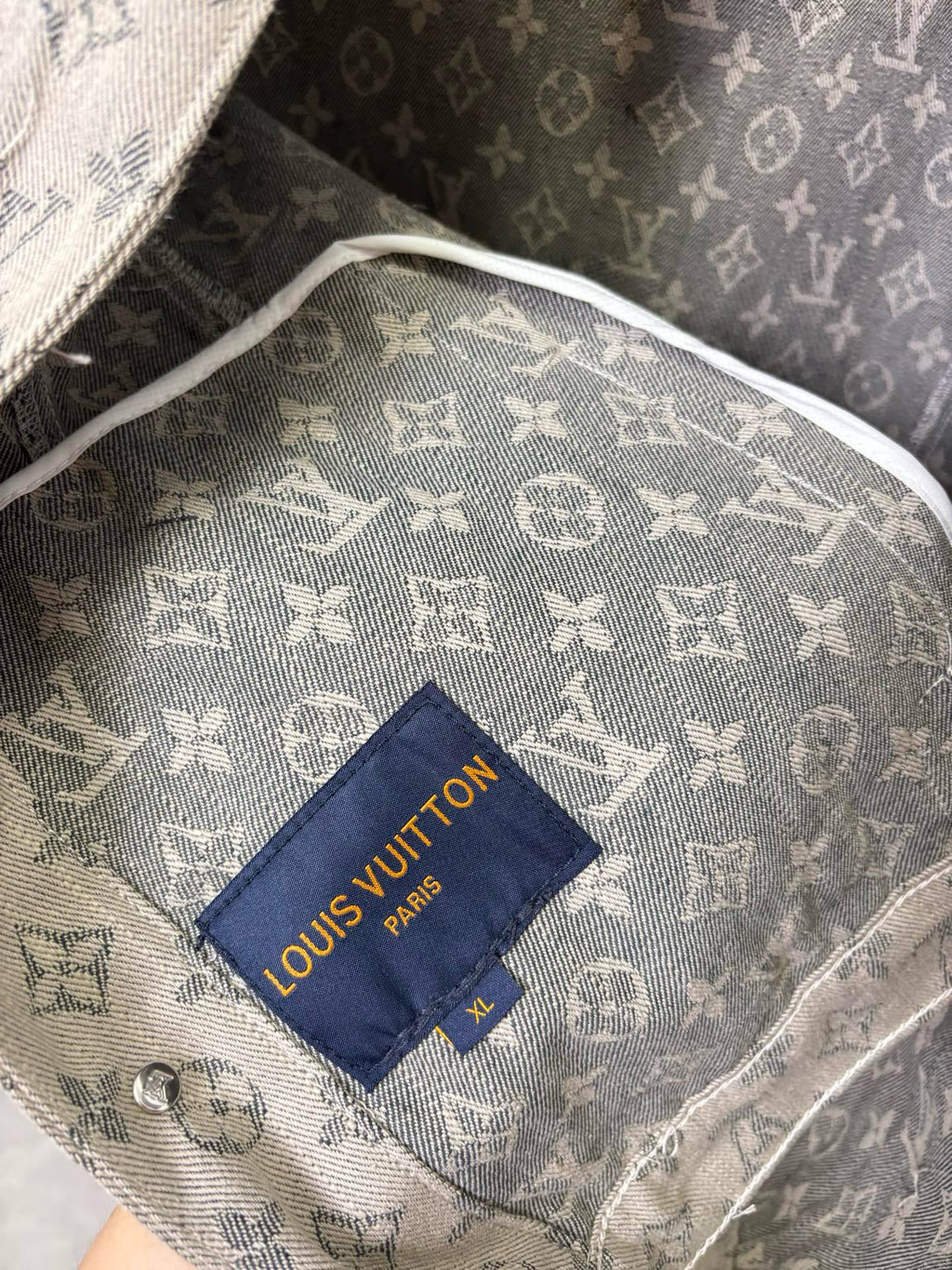 Louis Vuitton monogram jacket inner lining close-up with blue brand label