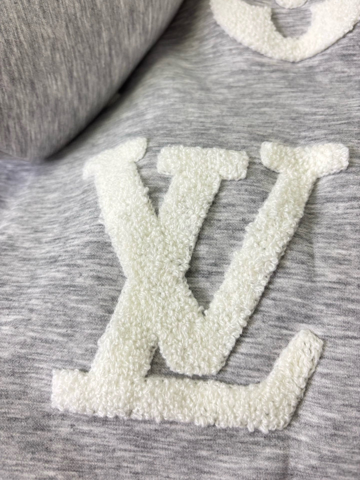 Louis Vuitton gray heather fabric with raised cream LV-style monogram print