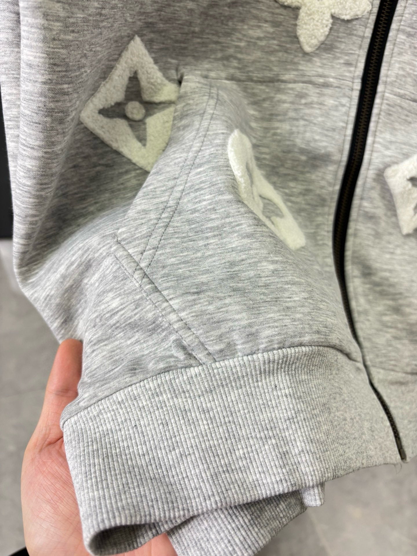 Gray zip-up long-sleeve sweatshirt with star appliques on the chest