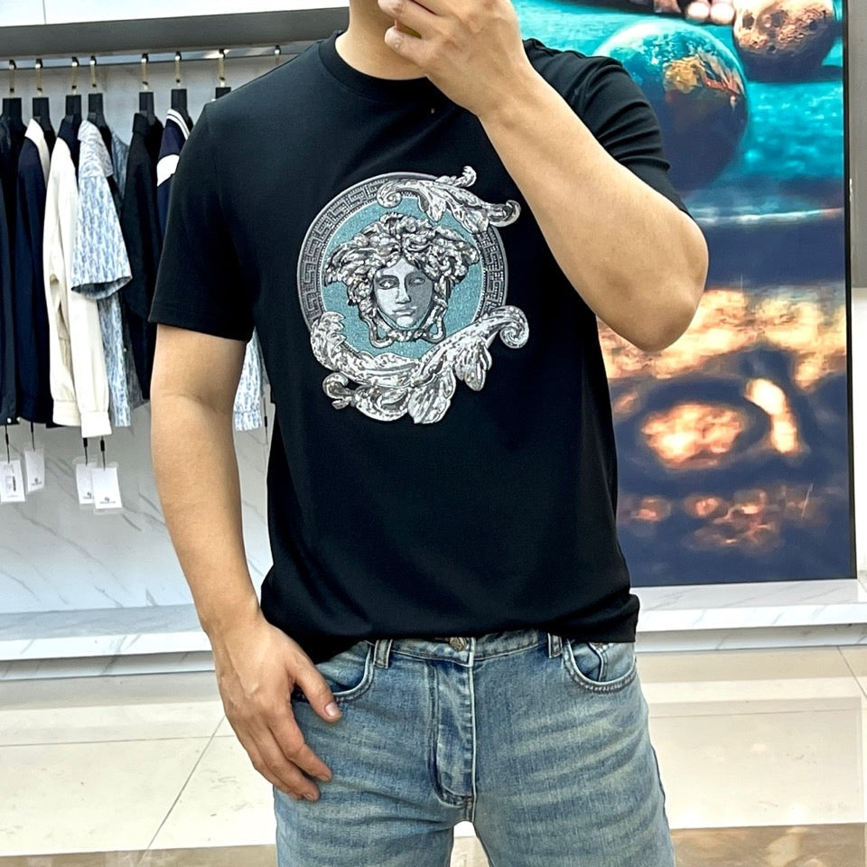 Versace black T-shirt with Medusa face print, worn with light blue jeans
