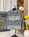 Louis Vuitton denim jacket with blue wash and gold monogram pattern, button front.