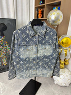 Louis Vuitton denim jacket front with blue wash, gold monogram print, flap chest pockets.
