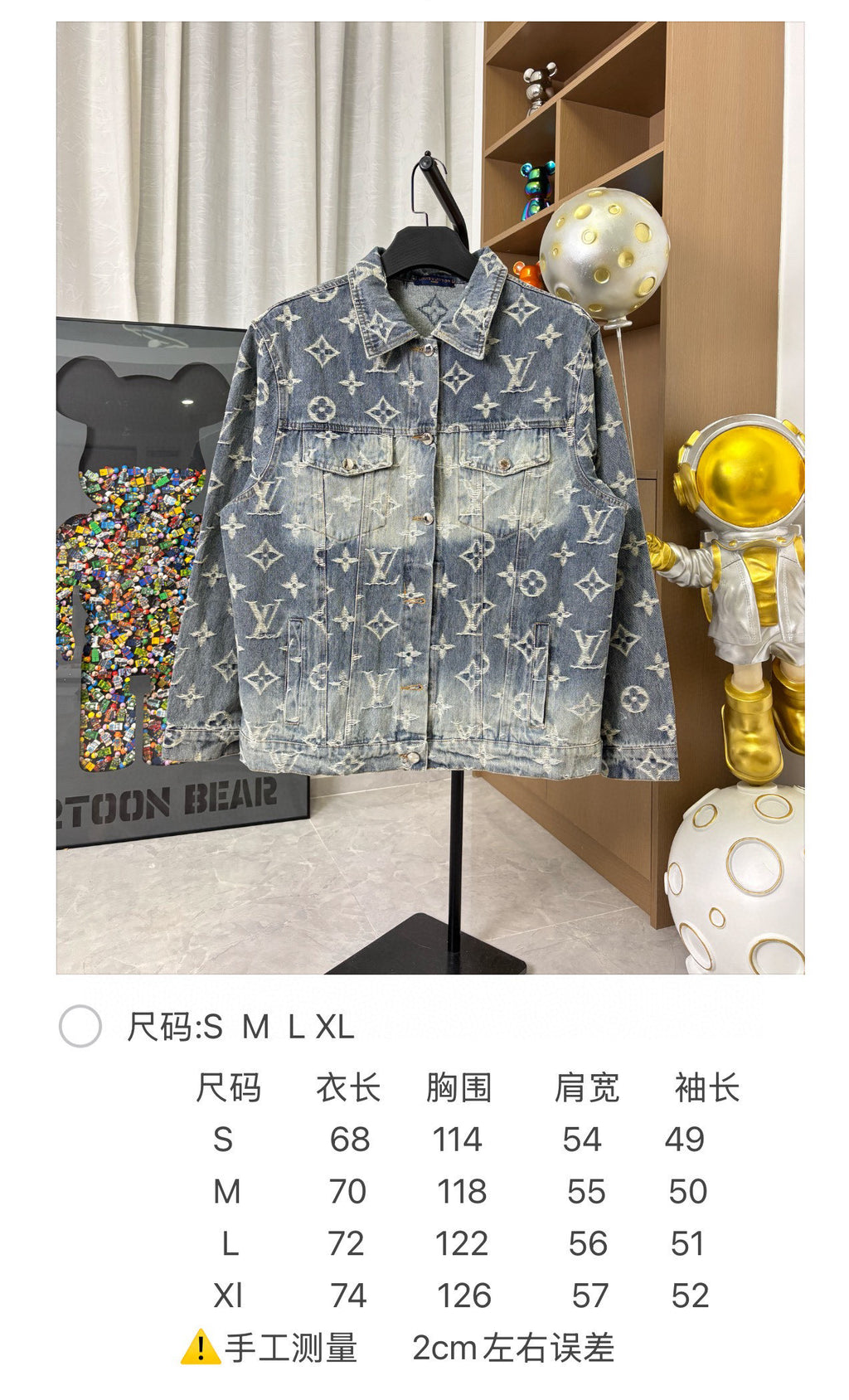 Louis Vuitton denim jacket front full view with blue wash and gold monogram pattern on hanger.