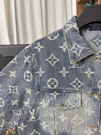 Louis Vuitton denim jacket shoulder and chest close-up with gold monogram print and pocket flap.
