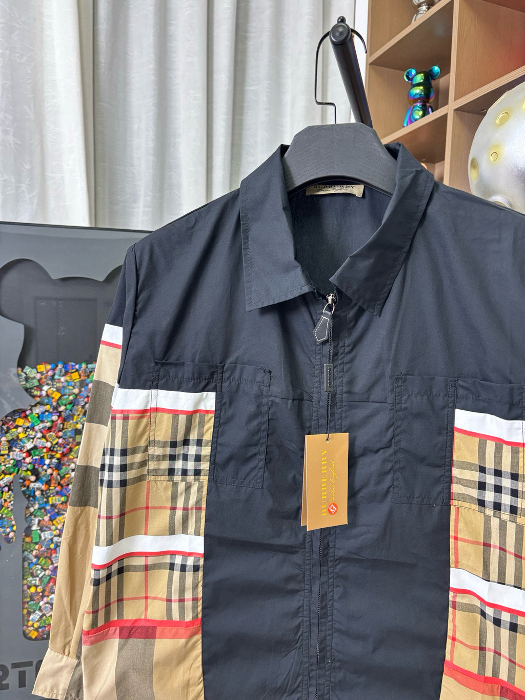 Burberry jacket with stand collar and front zipper; navy fabric with plaid panels