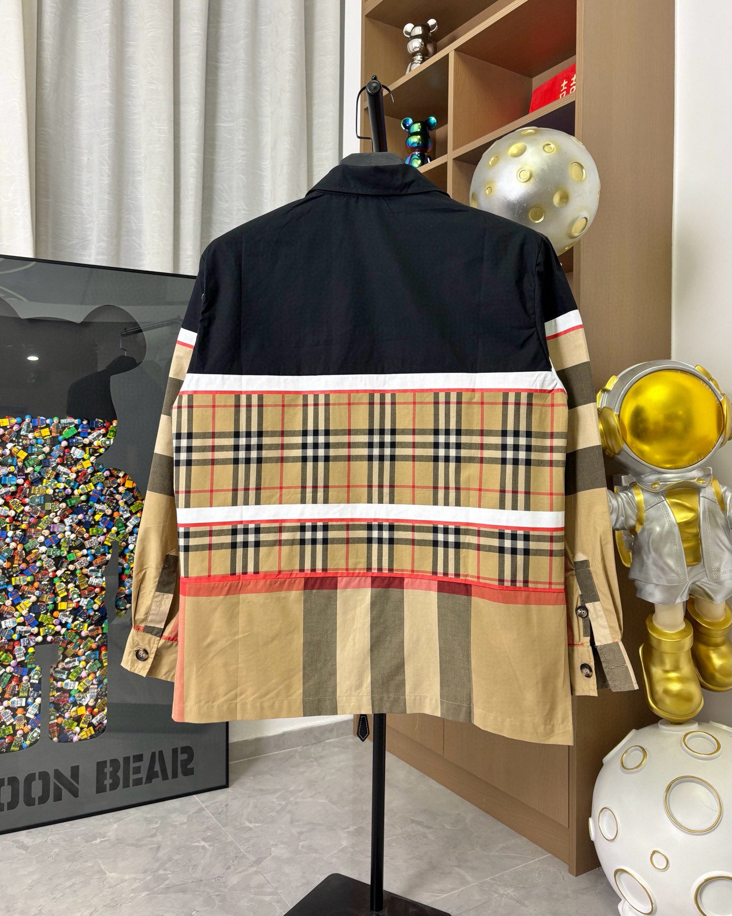 Burberry jacket back view in navy with plaid stripe panel and red trim