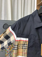 Burberry jacket close-up: navy shoulder with beige plaid stripe panel