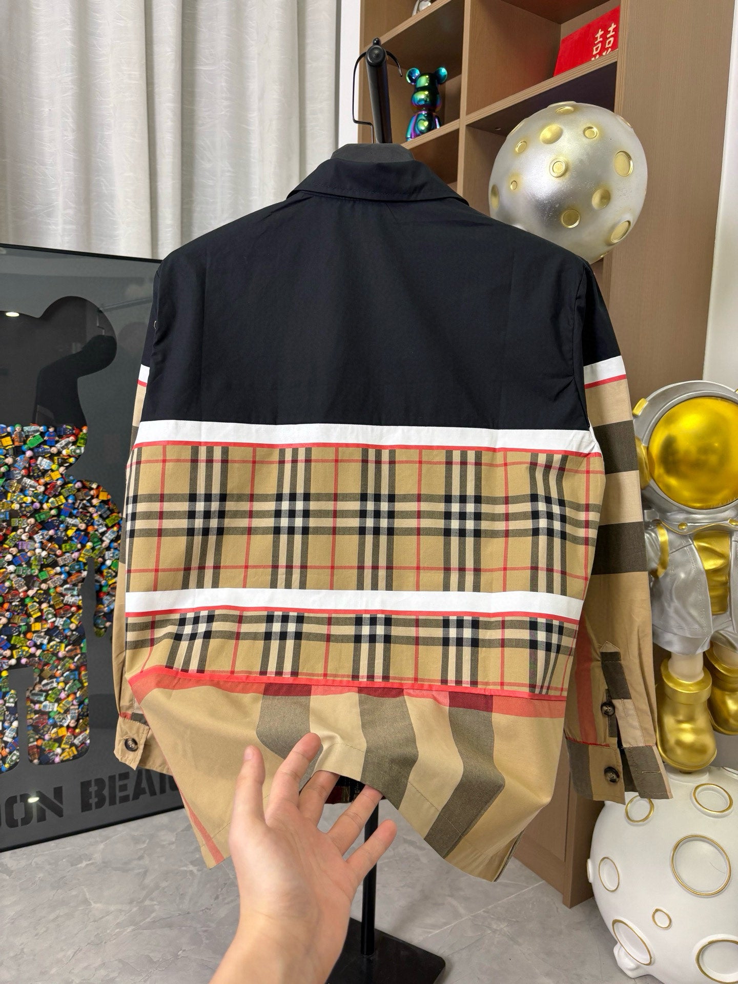 Burberry jacket back with navy top and beige plaid stripe band, red piping