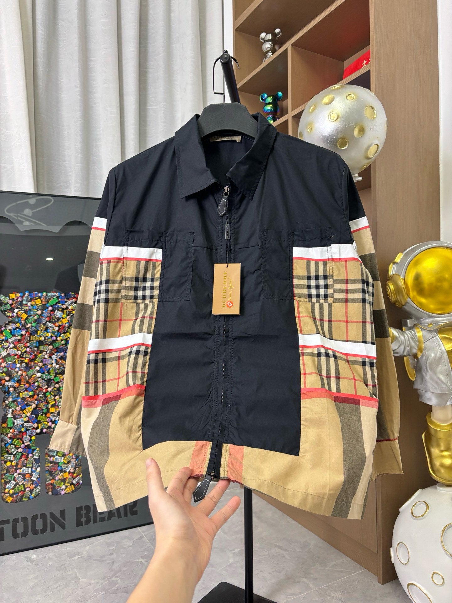 Burberry jacket front with navy top and beige plaid side panels, zip-up