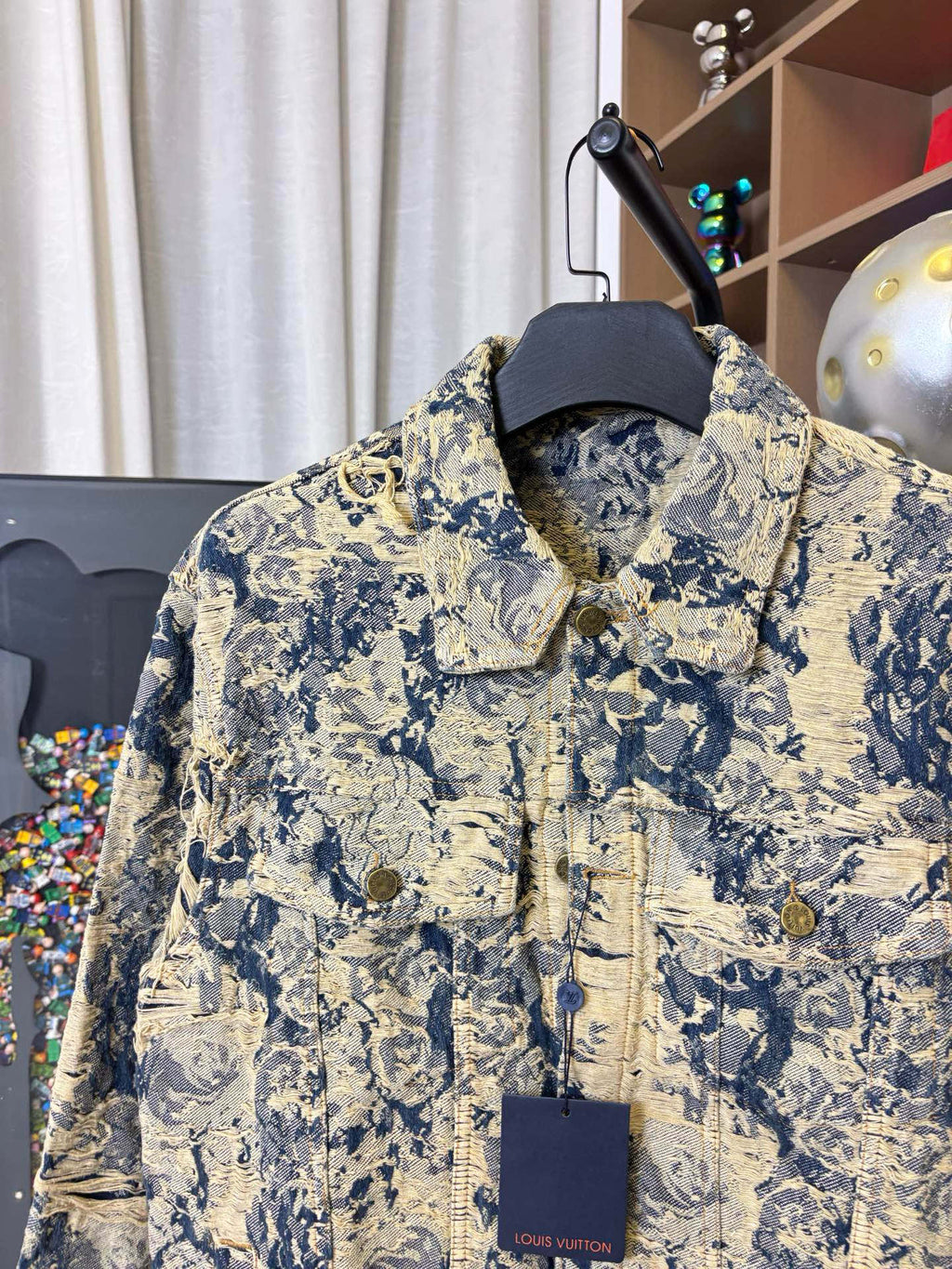Long-sleeve jacket front view with button placket and blue-and-cream print