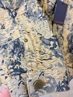Long-sleeve jacket chest detail with embossed texture and round button