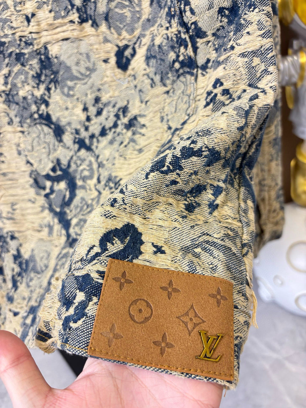 Long-sleeve jacket hem with tan patch and blue-and-cream fabric