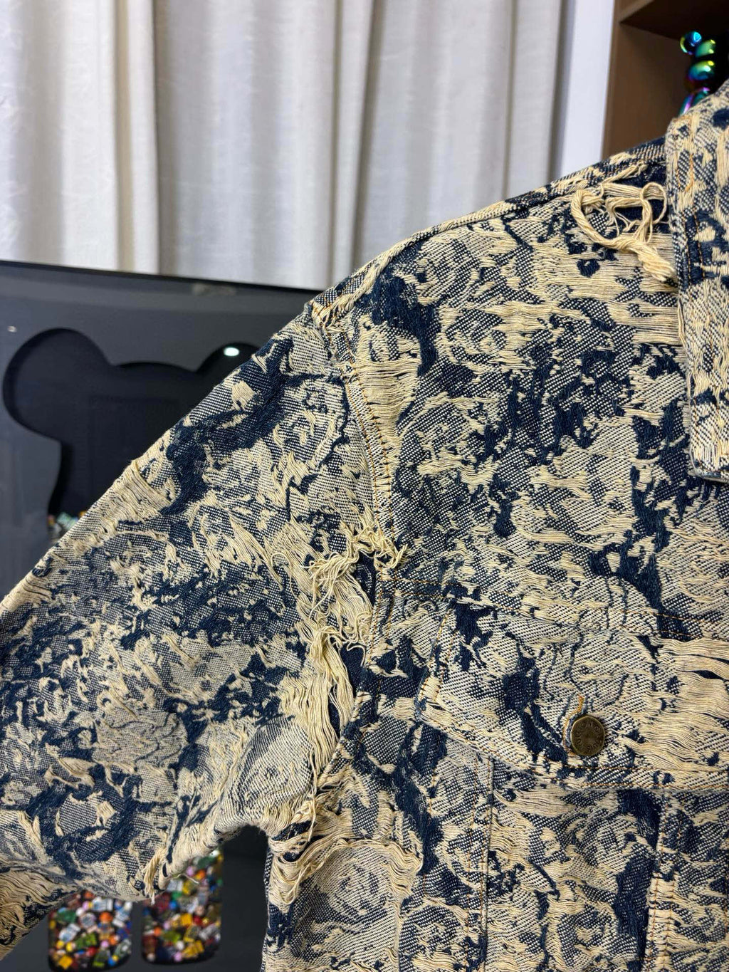 Long-sleeve jacket sleeve close-up with blue and cream textured pattern