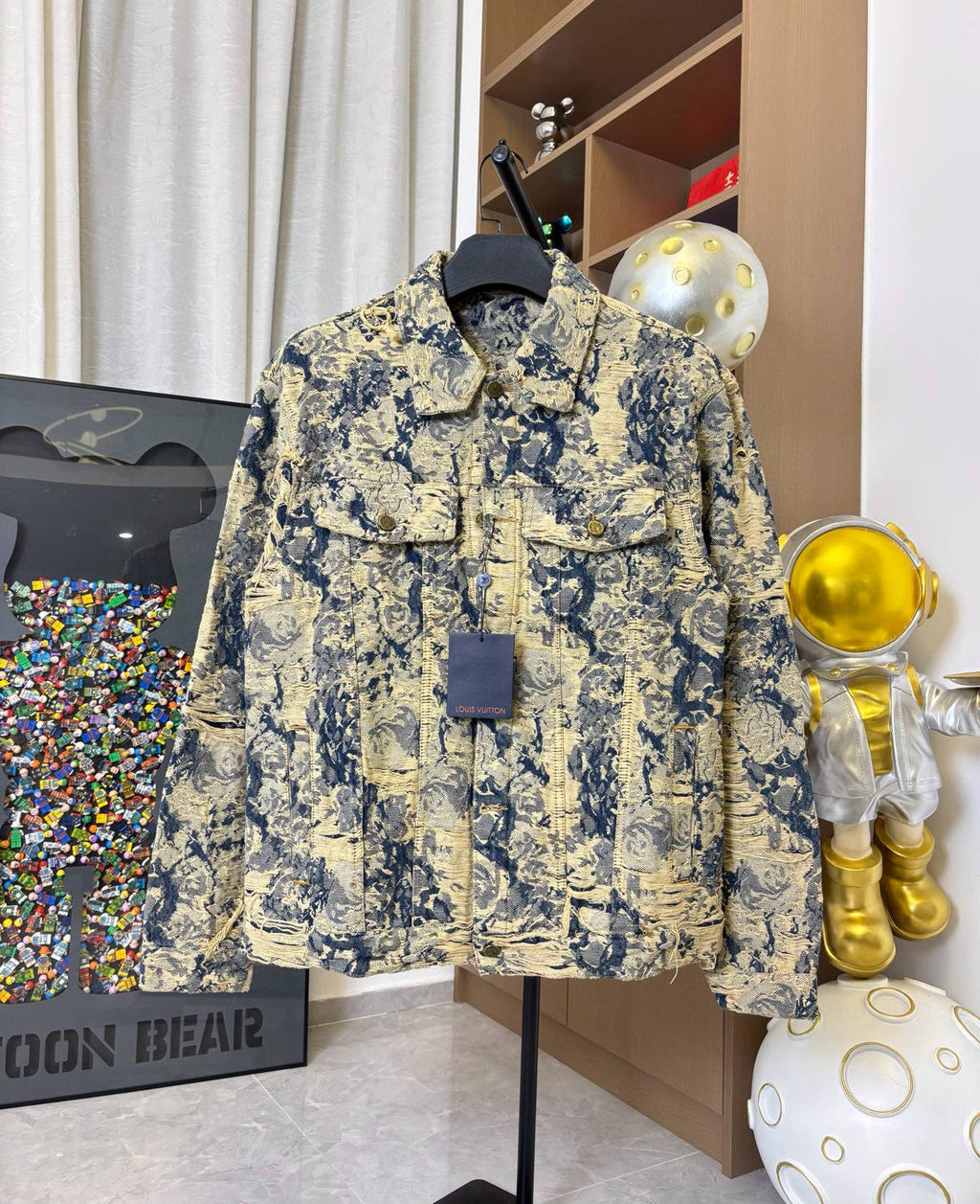 Long-sleeve jacket on hanger with blue and cream abstract fabric and pocket