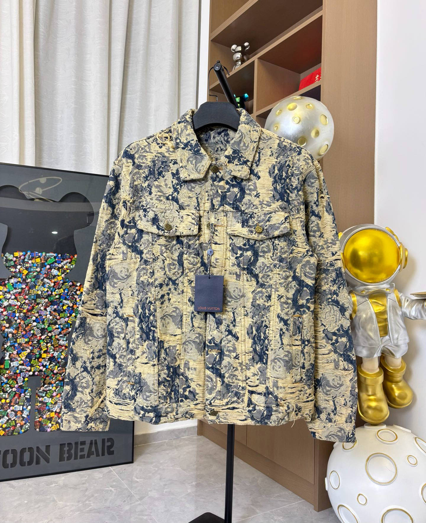 Long-sleeve jacket on hanger with blue and cream abstract fabric and pocket