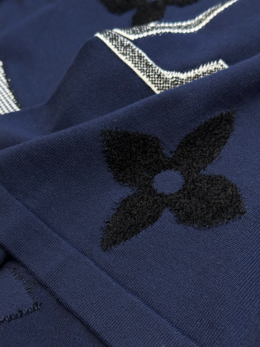Navy T-shirt with black clover flower appliques and rhinestone lettering detail