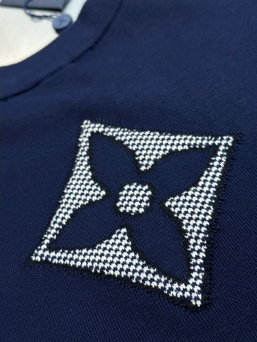 Navy T-shirt with rhinestone star badge and central quatrefoil logo