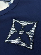 Navy T-shirt with rhinestone star badge and central quatrefoil logo
