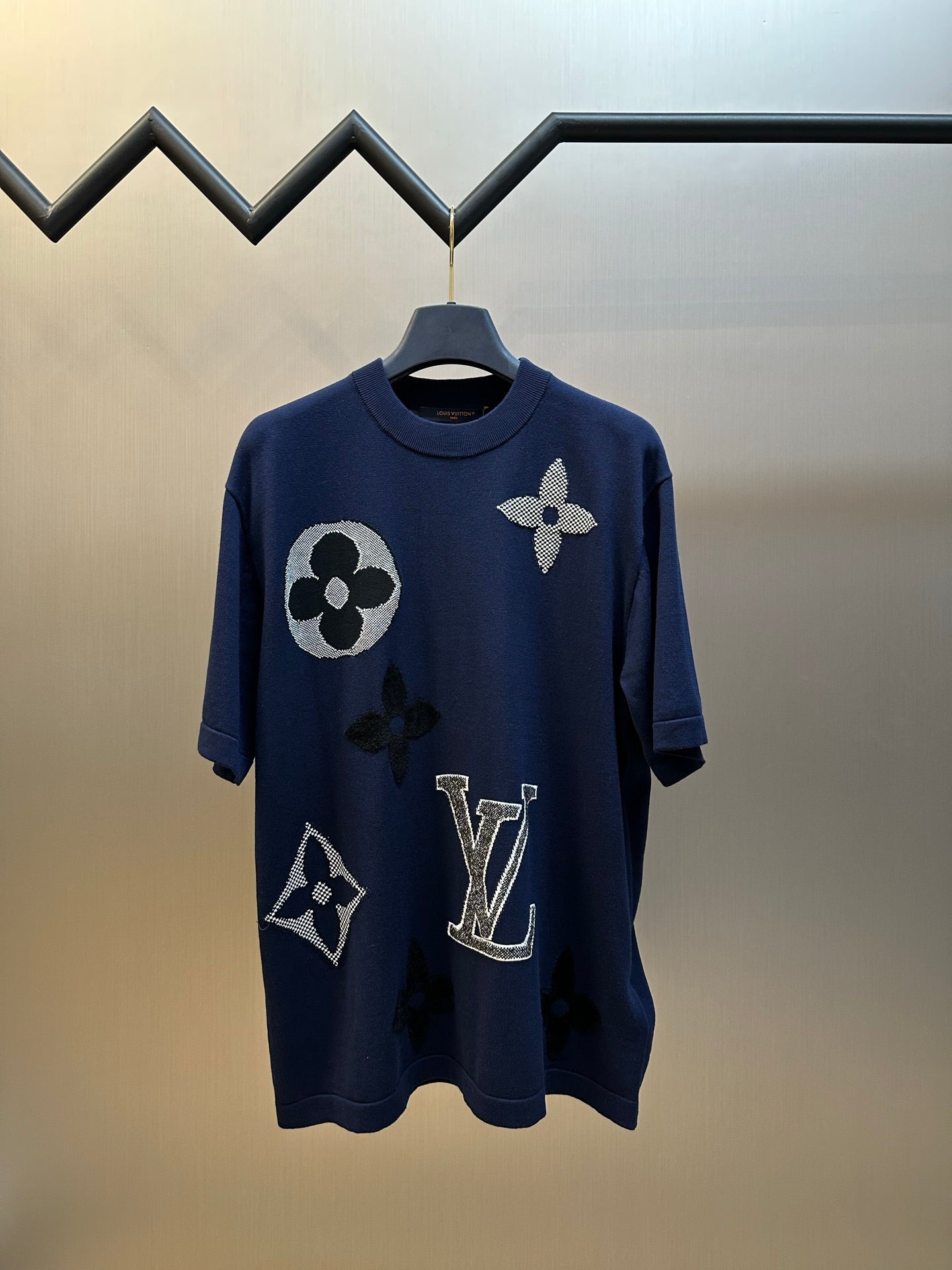 Navy crew-neck T-shirt with large logo and flower appliques, on hanger