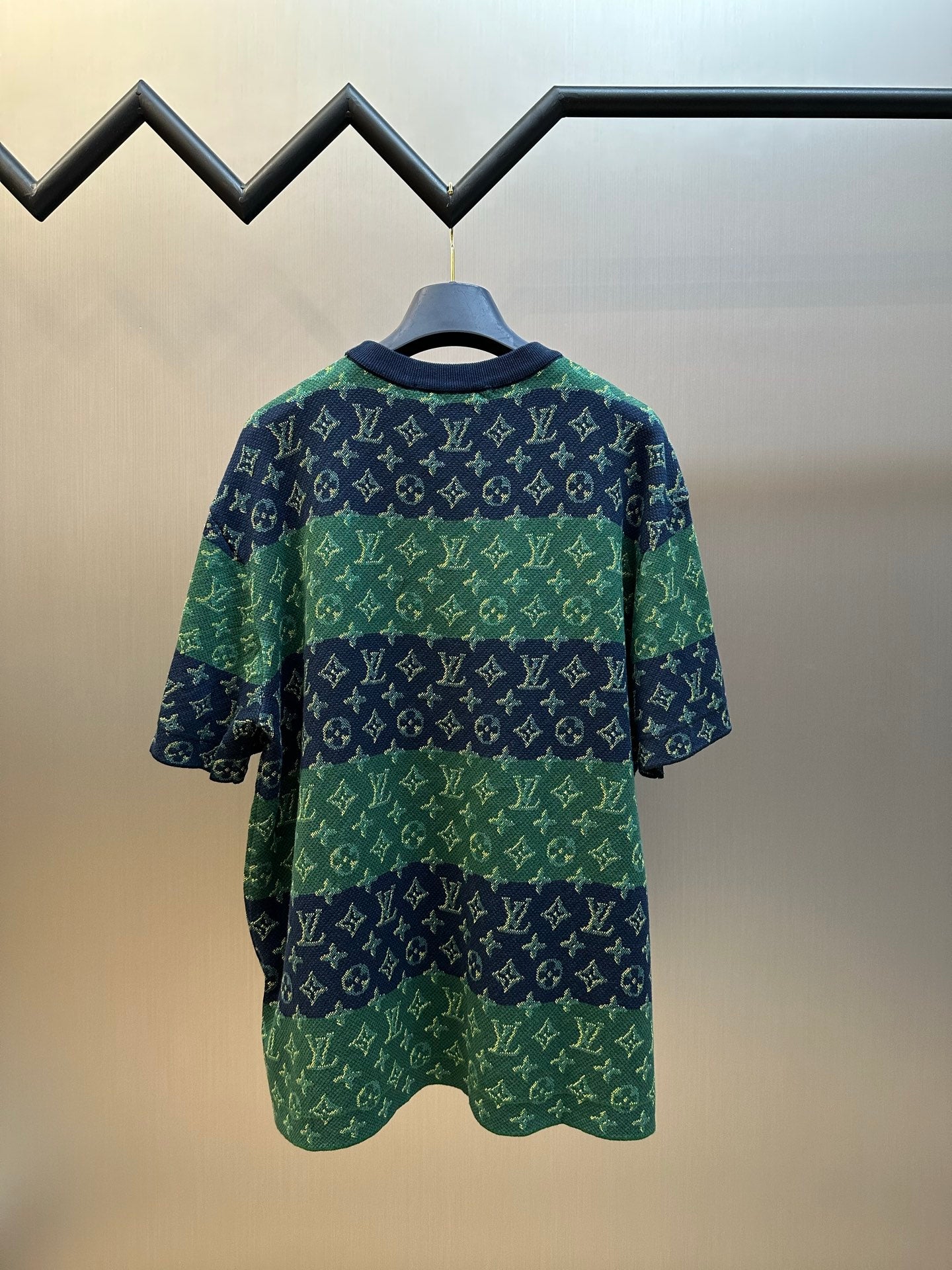 Knit short-sleeve top back view with navy-and-green monogram pattern