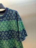 Knit short-sleeve top sleeve detail with navy trim and green monogram pattern