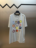 Grey T-shirt with multi-color logo patch graphic on the front
