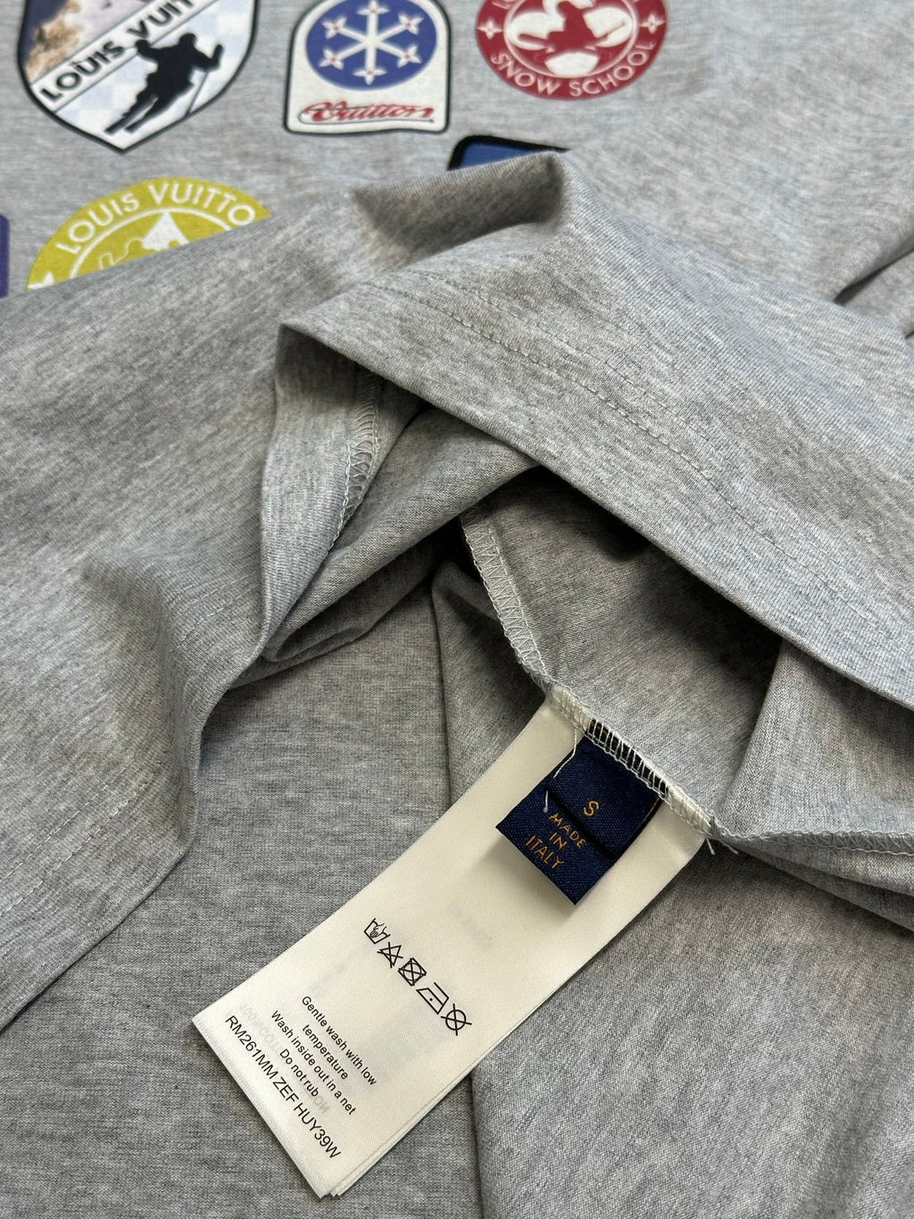 Grey T-shirt with draped fabric and inner neck label tag
