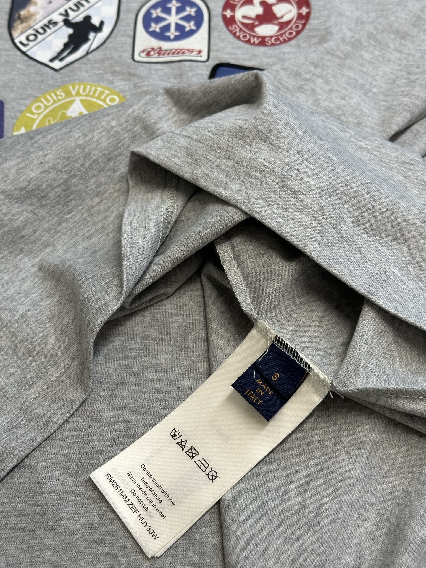 Grey T-shirt with draped fabric and inner neck label tag