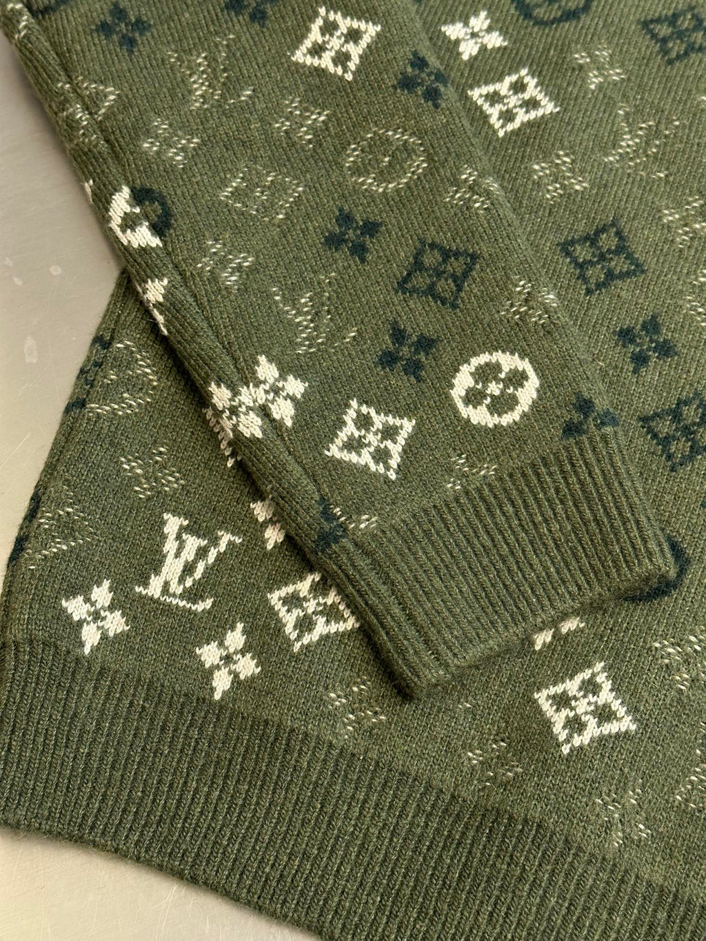 Louis Vuitton knit sweater hem detail in olive green with monogram pattern knit texture