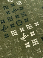 Louis Vuitton knit sweater fabric close-up in olive green with monogram pattern