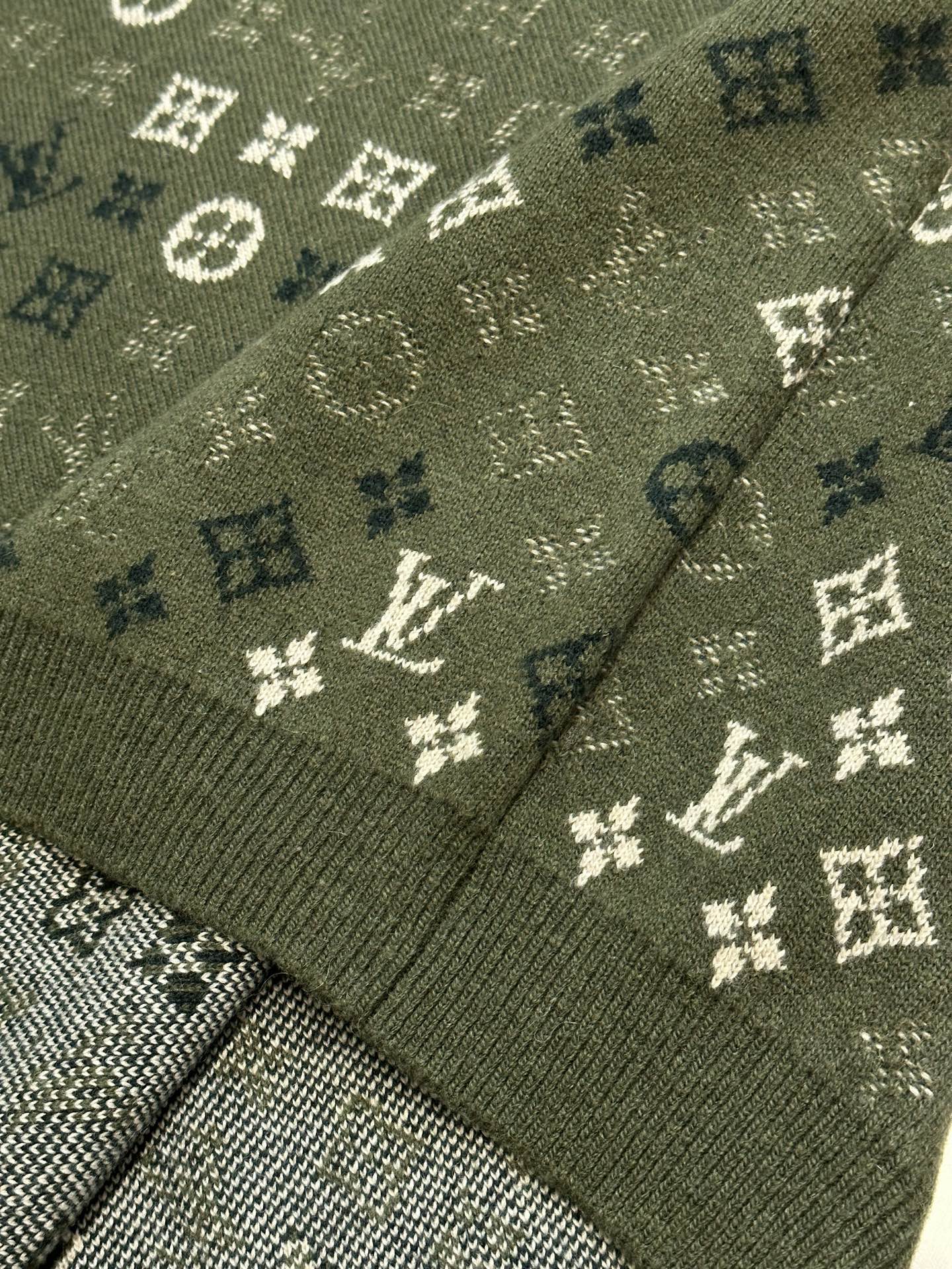 Louis Vuitton knit sweater cuff and hem close-up in olive green with monogram pattern