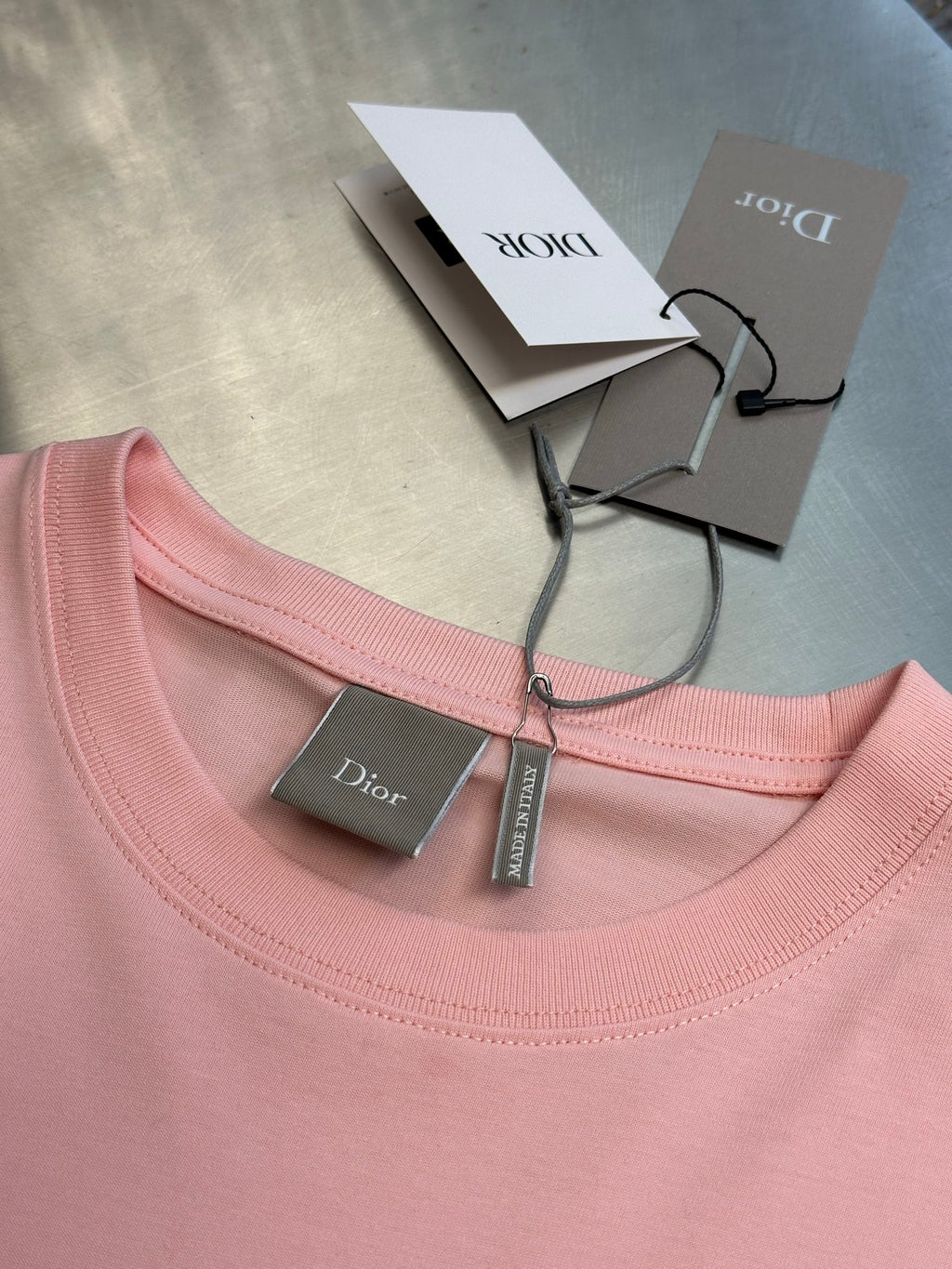Pink Dior T-shirt neckline with green care tag and small chest logo