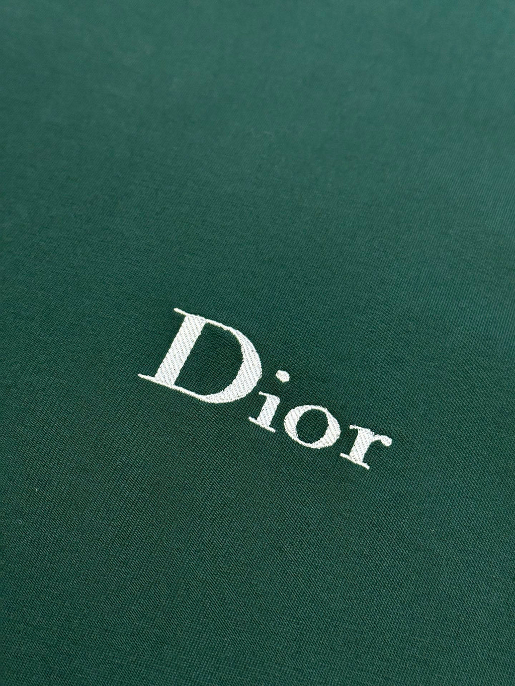 White Dior logo print on dark green Dior short-sleeve T-shirt fabric