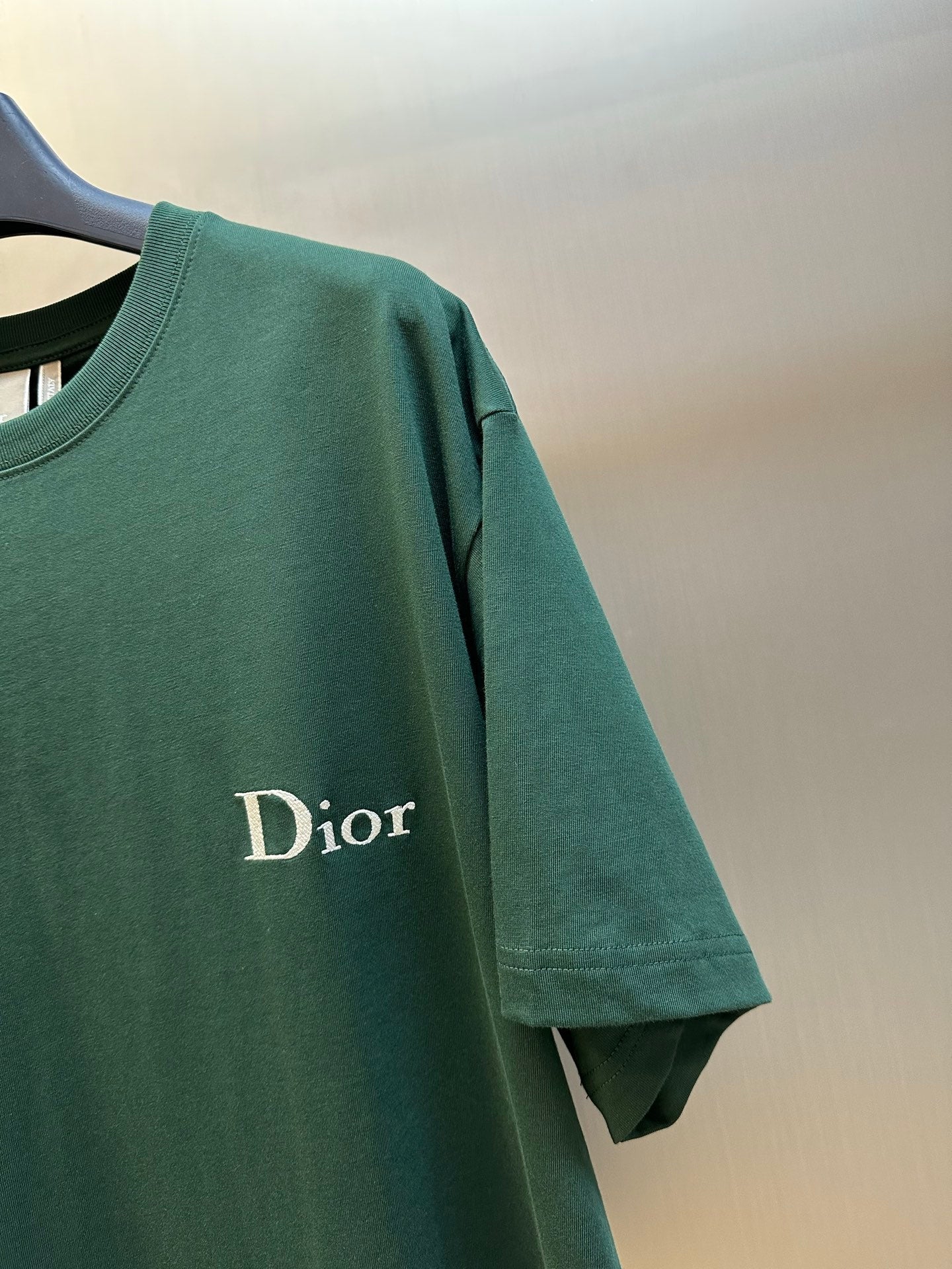 Green T-shirt with partial Dior logo on the front sleeve