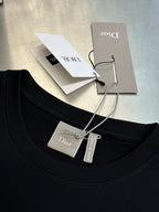 Dior crewneck T-shirt neckline in dark navy with hanging price and care tags