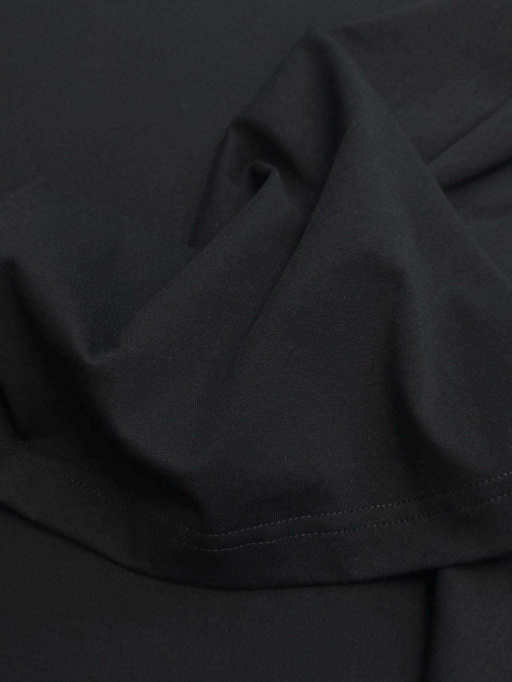 Black Dior T-shirt hem with visible stitching