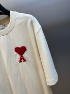 Off-white T-shirt sleeve with a red embroidered emblem on the front