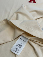Cream T-shirt fabric fold with white size label tag attached