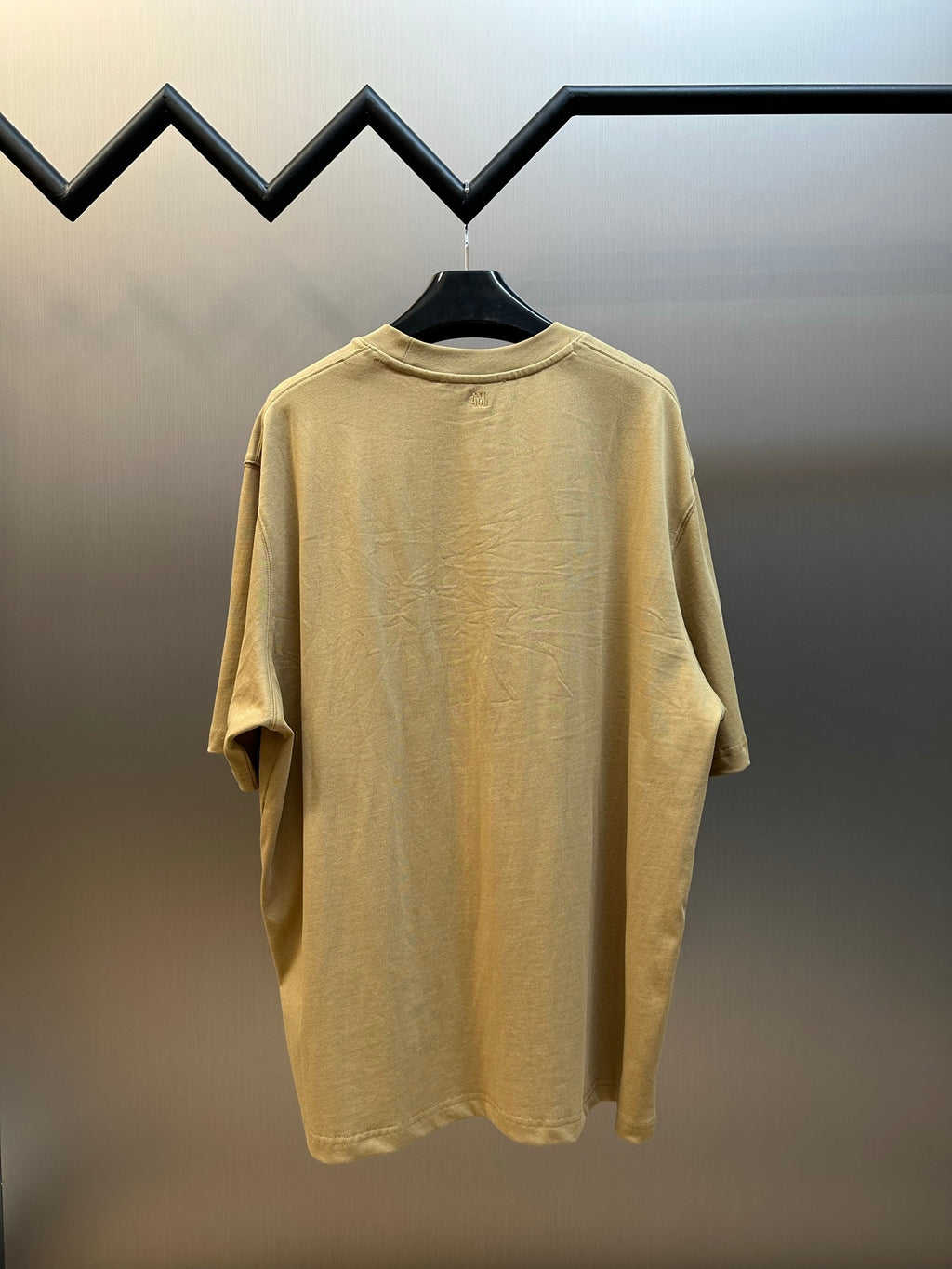 Beige T-shirt back view with crew neck and short sleeves