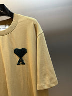 Beige T-shirt with black graphic detail on the front