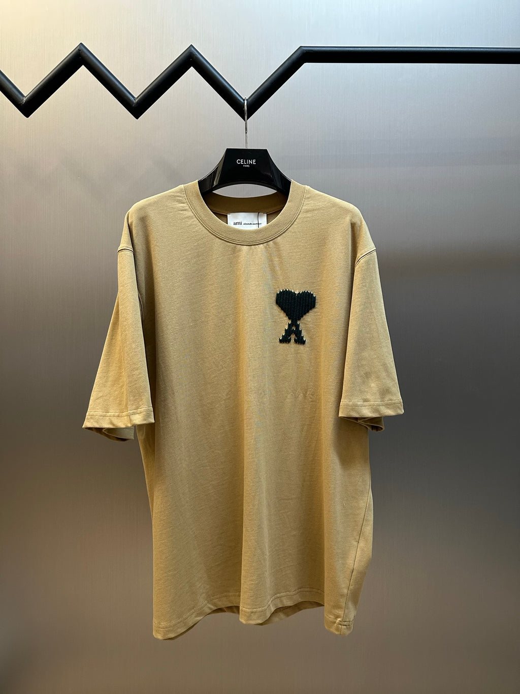 Beige crewneck T-shirt with short sleeves and black graphic on chest