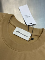 Beige T-shirt neckline with stitched crew collar and hanging tags