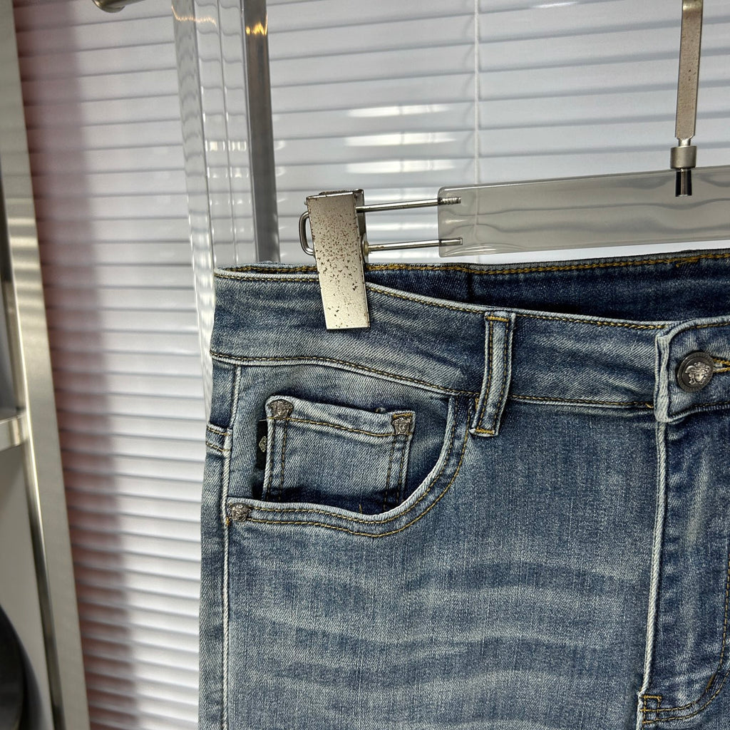 Light blue denim jeans with front coin pocket and stitched pocket edges