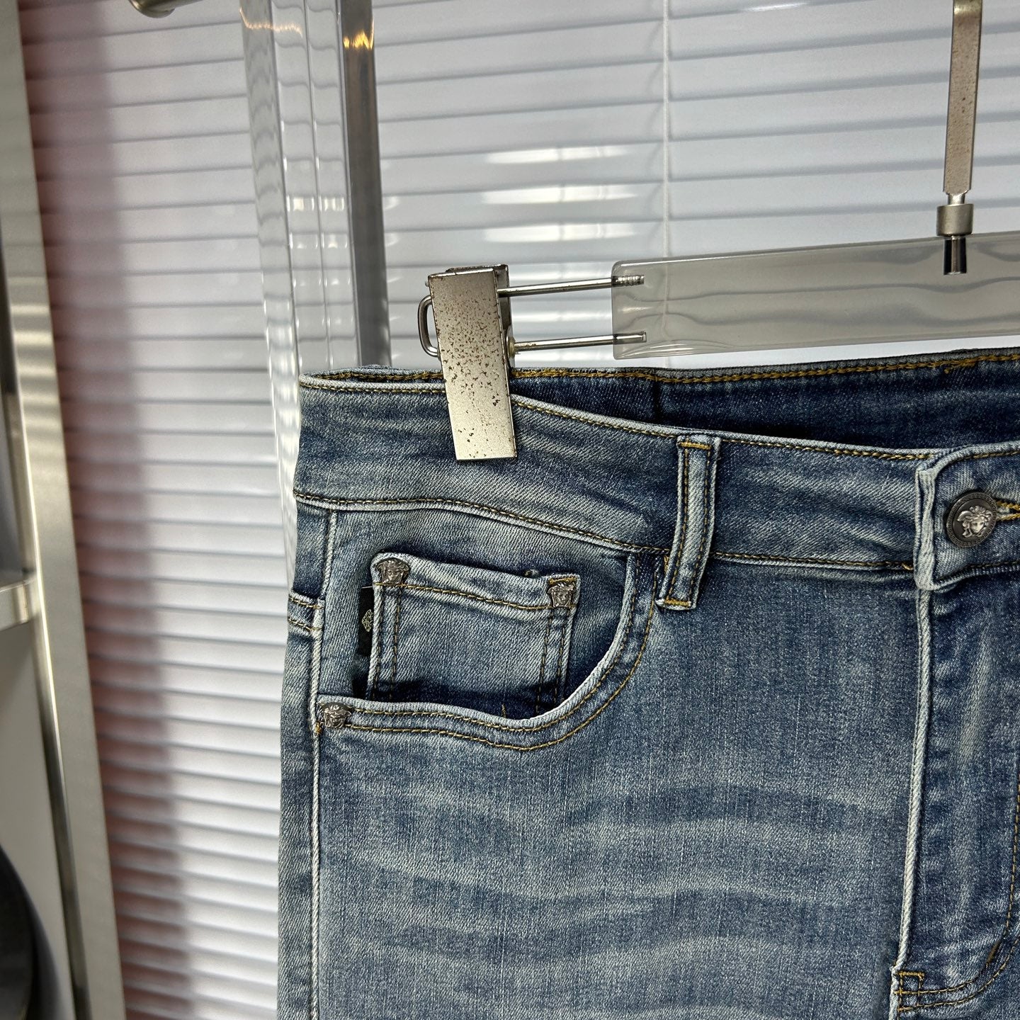Light blue denim jeans with front coin pocket and stitched pocket edges
